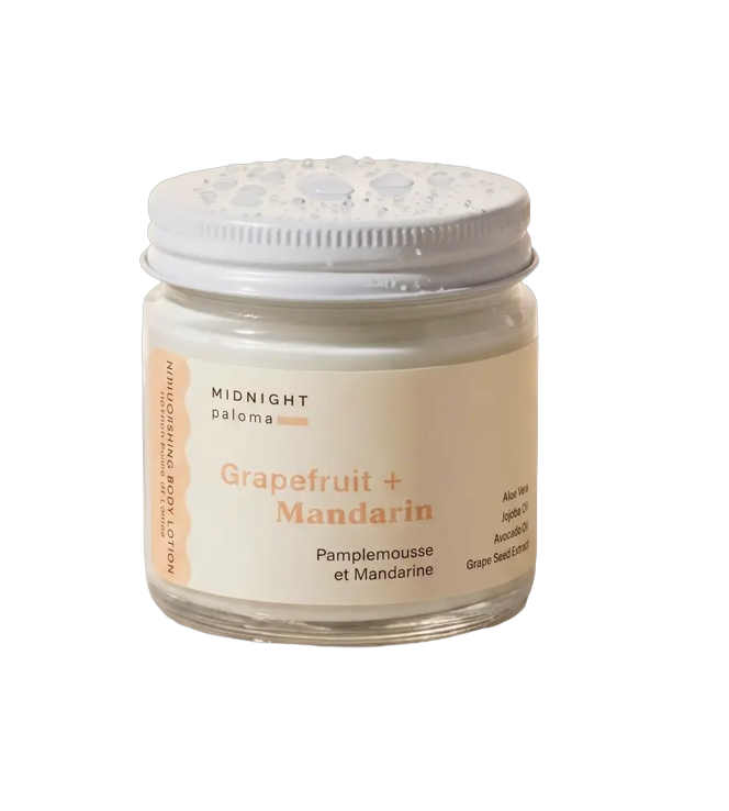 Mimro Midnight Paloma grapefruit and mandarin body lotion with aloe vera and jojoba oil, shown in a sleek bottle with fresh citrus slices